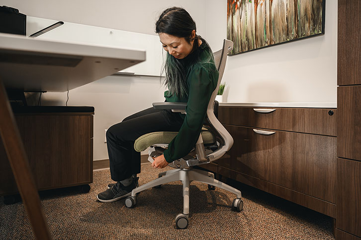 office worker adjusting ergonomic office chair